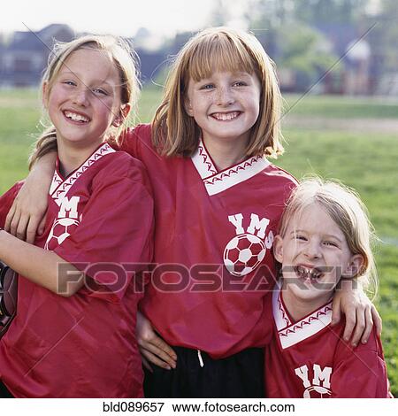Stock Photo - Grinning soccer players hugging. Fotosearch