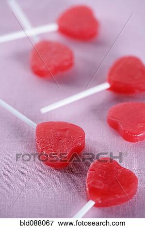 Group of red heart-shape lollipops View Large Photo Image Stock Photo - Group of red heart-shape lollipops. Fotosearch
