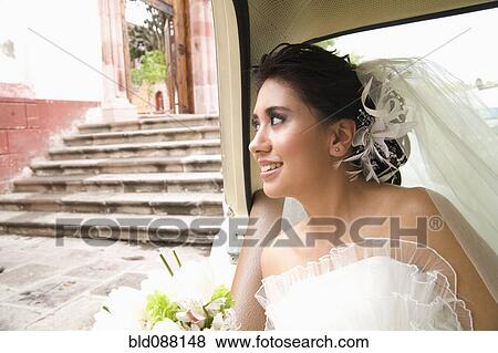 Hispanic bride sitting with bouquet in back of car View Large Photo Image Stock Photo - Hispanic bride sitting with bouquet in back of car. Fotosearch
