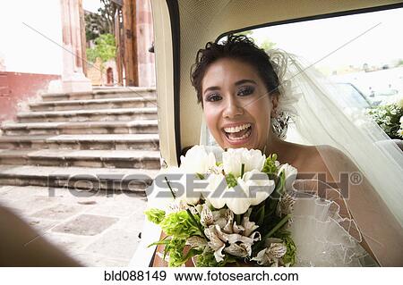 Hispanic bride sitting with bouquet in back of car View Large Photo Image Stock Photo - Hispanic bride sitting with bouquet in back of car. Fotosearch