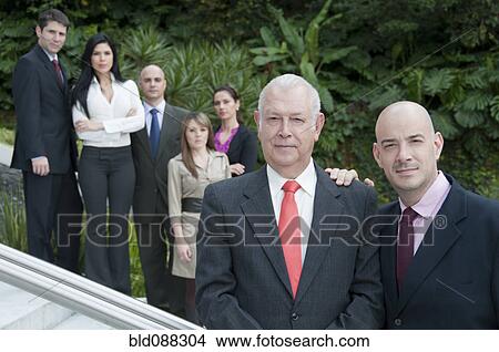 Picture - Hispanic business people standing on stairs together outdoors. Fotosearch