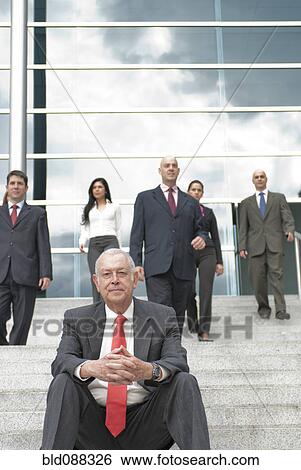 Hispanic business people standing on stairs together outdoors View Large Photo Image Stock Photograph - Hispanic business people standing on stairs together outdoors. Fotosearch