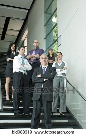 Stock Photo - Hispanic business people standing together on staircase. Fotosearch