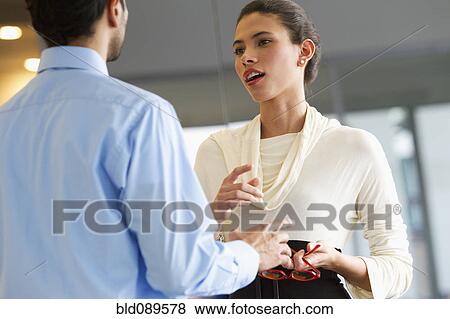 Hispanic business people talking together in office View Large Photo Image Stock Photo - Hispanic business people talking together in office. Fotosearch