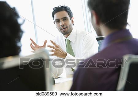 Stock Photo - Hispanic business people working together in office. Fotosearch