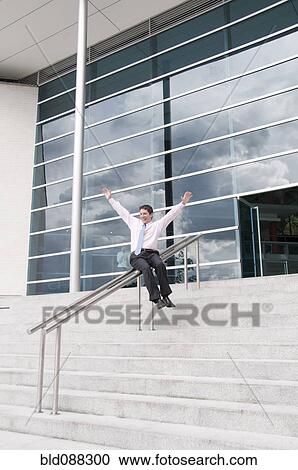 Hispanic businessman sliding down railing View Large Photo Image Stock Image - Hispanic businessman sliding down railing. Fotosearch
