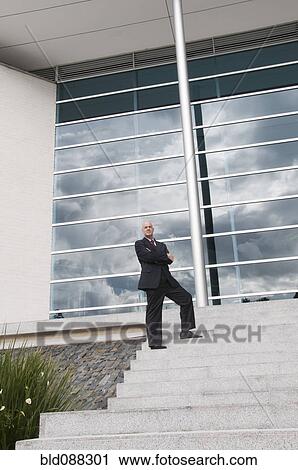 Hispanic businessman standing on staircase outdoors View Large Photo Image Stock Image - Hispanic businessman standing on staircase outdoors. Fotosearch