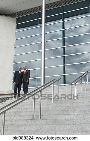 Hispanic businessmen standing on stairs View Large Photo Image Picture - Hispanic businessmen standing on stairs. Fotosearch
