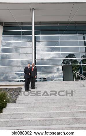 Hispanic businessmen standing on staircase outdoors View Large Photo Image Stock Image - Hispanic businessmen standing on staircase outdoors. Fotosearch