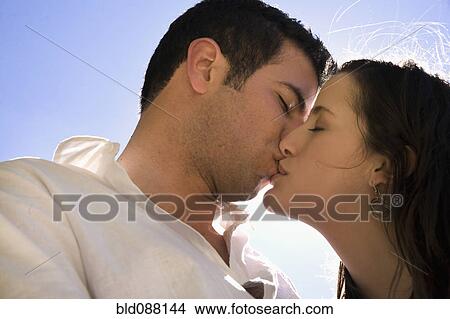 Picture - Hispanic couple kissing. Fotosearch