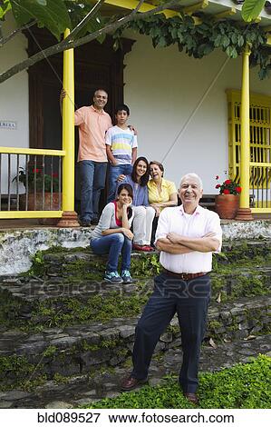 Stock Photo - Hispanic family on house steps together. Fotosearch