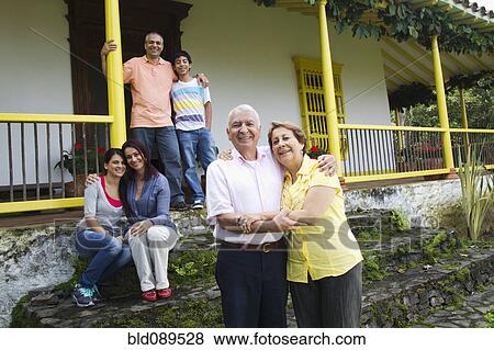 Stock Photo - Hispanic family on house steps together. Fotosearch