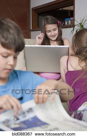 Stock Photo - Hispanic family relaxing together. Fotosearch