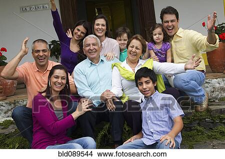 Hispanic family sitting on steps together waving View Large Photo Image Picture - Hispanic family sitting on steps together waving. Fotosearch