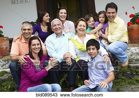 Stock Image - Hispanic family sitting on steps together. Fotosearch