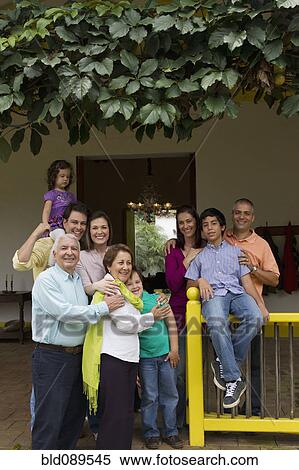 Stock Photography - Hispanic family standing on porch together. Fotosearch