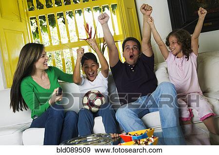 Hispanic family watching soccer on television View Large Photo Image Stock Photo - Hispanic family watching soccer on television. Fotosearch
