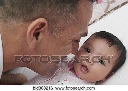 Hispanic father bonding with baby daughter View Large Photo Image Stock Photograph - Hispanic father bonding with baby daughter. Fotosearch