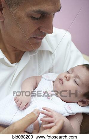 Hispanic father holding baby daughter View Large Photo Image Stock Photo - Hispanic father holding baby daughter. Fotosearch