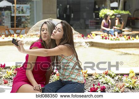 Hispanic friends taking self-portrait View Large Photo Image Stock Image - Hispanic friends taking self-portrait. Fotosearch