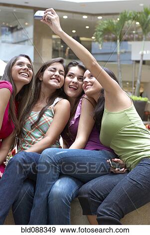 Hispanic friends taking self-portrait View Large Photo Image Stock Photo - Hispanic friends taking self-portrait. Fotosearch