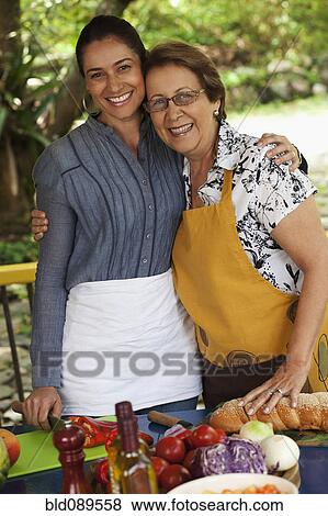 Hispanic mother and daughter cooking together View Large Photo Image Stock Photo - Hispanic mother and daughter cooking together. Fotosearch