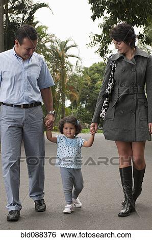 Hispanic parents holding daughter's hands outdoors View Large Photo Image Stock Photograph - Hispanic parents holding daughter's hands outdoors. Fotosearch