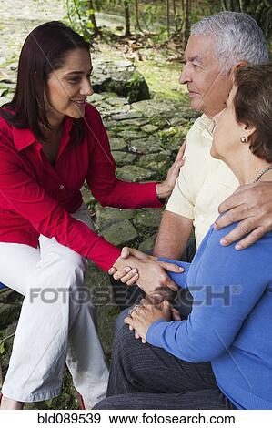 Hispanic woman giving senior Hispanic couple bad news View Large Photo Image Stock Photo - Hispanic woman giving senior Hispanic couple bad news. Fotosearch