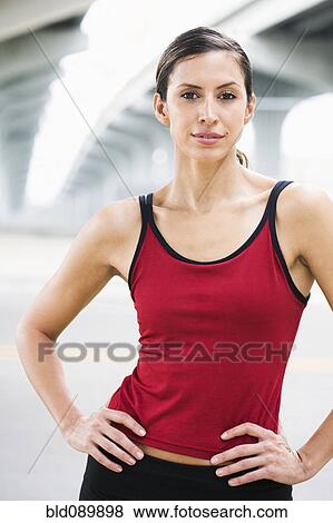 Hispanic woman in sportswear standing in urban area View Large Photo Image Stock Photo - Hispanic woman in sportswear standing in urban area. Fotosearch
