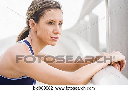 Stock Image - Hispanic woman resting after exercise. Fotosearch