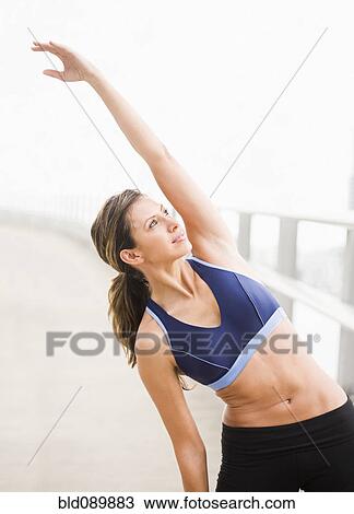 Hispanic woman stretching before exercise View Large Photo Image Stock Image - Hispanic woman stretching before exercise. Fotosearch