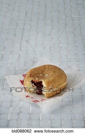 Jelly donut on bathroom floor View Large Photo Image Stock Image - Jelly donut on bathroom floor. Fotosearch