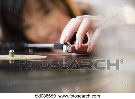 Korean woman putting playing arm on record View Large Photo Image Stock Photo - Korean woman putting playing arm on record. Fotosearch