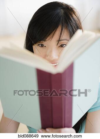 Stock Photo - Korean woman reading book. Fotosearch
