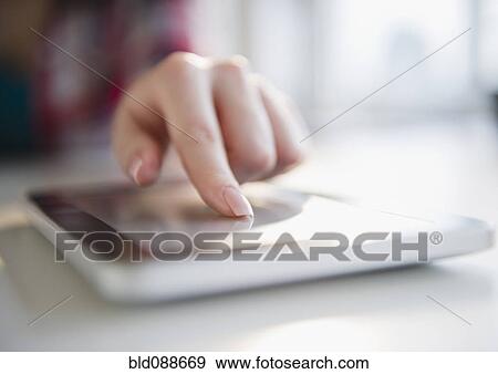 Stock Photo - Korean woman using digital tablet. Fotosearch