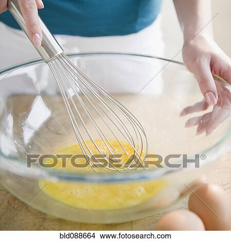 Korean woman whisking eggs in bowl View Large Photo Image Picture - Korean woman whisking eggs in bowl. Fotosearch