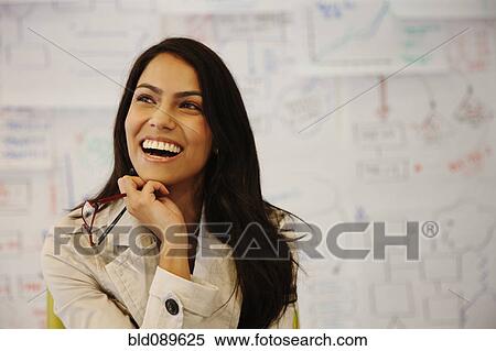 Stock Photography - Laughing businesswoman in office. Fotosearch