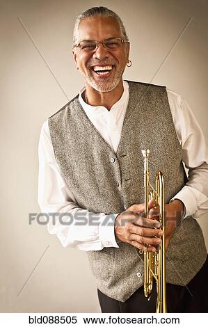 Laughing musician holding trumpet View Large Photo Image Stock Photography - Laughing musician holding trumpet. Fotosearch