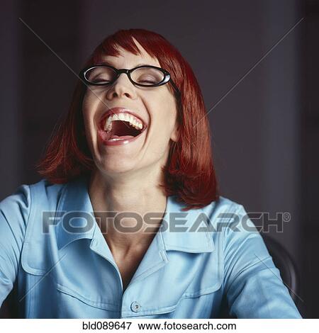 Stock Photo - Laughing redheaded, mixed race businesswoman. Fotosearch