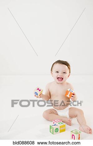 Stock Photo - Mixed race baby playing with alphabet blocks. Fotosearch