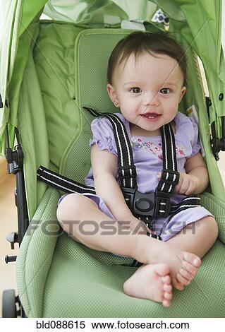 Stock Photography - Mixed race baby sitting in stroller. Fotosearch