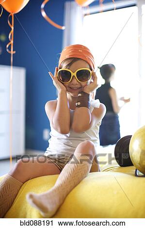 Mixed race girl at party wearing sunglasses View Large Photo Image Stock Image - Mixed race girl at party wearing sunglasses. Fotosearch