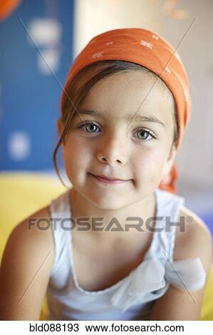 Stock Image - Mixed race girl wearing bandana. Fotosearch