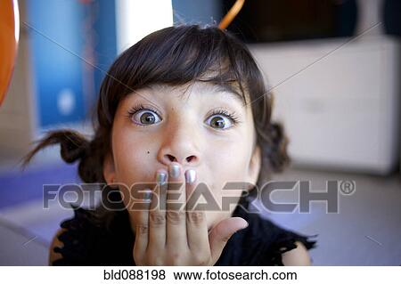 Mixed race girl with hand over mouth View Large Photo Image Stock Photo - Mixed race girl with hand over mouth. Fotosearch