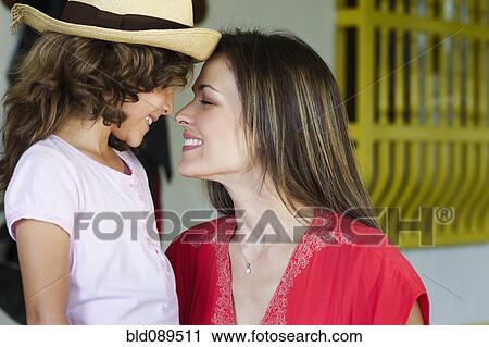 Stock Image - Mother smiling at daughter. Fotosearch