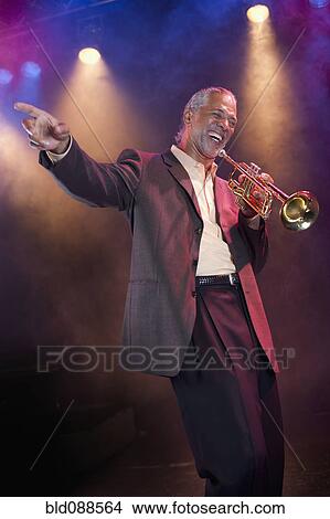 Musician playing trumpet on stage View Large Photo Image Picture - Musician playing trumpet on stage. Fotosearch