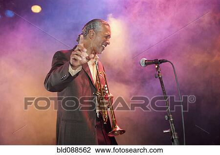 Musician playing trumpet on stage View Large Photo Image Stock Image - Musician playing trumpet on stage. Fotosearch