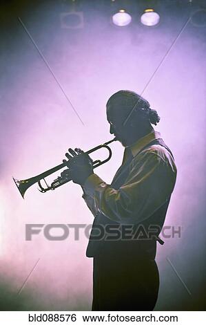 Stock Photograph - Musician playing trumpet on stage. Fotosearch