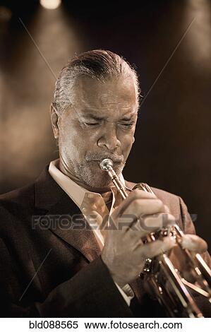 Musician playing trumpet on stage View Large Photo Image Stock Photography - Musician playing trumpet on stage. Fotosearch