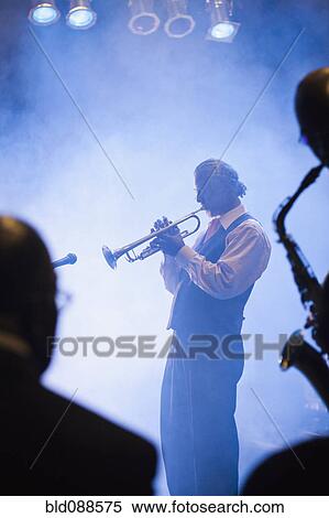 Musician playing trumpet on stage View Large Photo Image Stock Photography - Musician playing trumpet on stage. Fotosearch